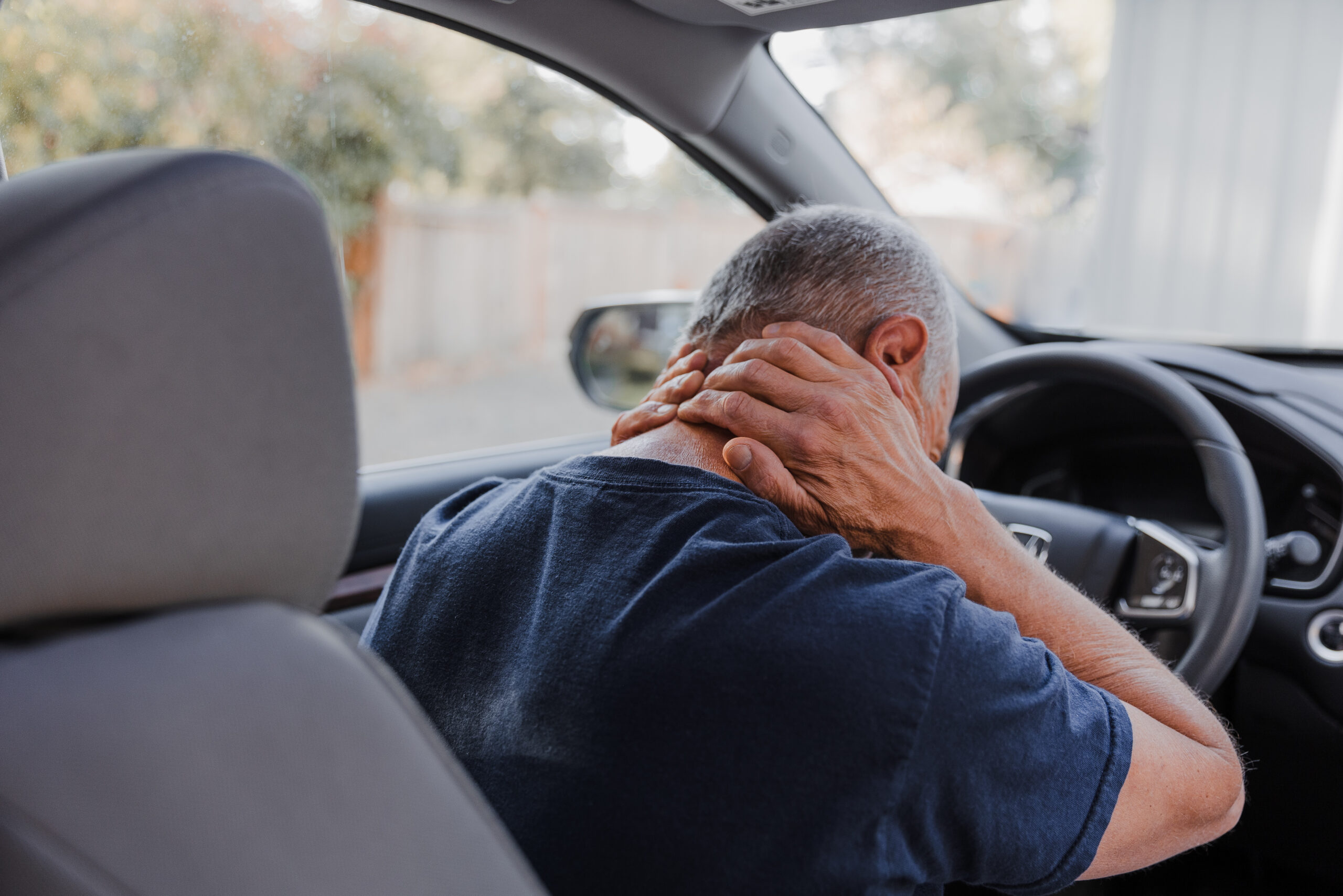 Middle-aged man with neck pain after being rear ended in a car accident