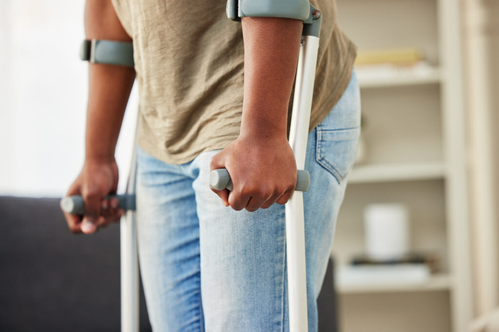 person  using walking crutches after their injury caused by a car accident