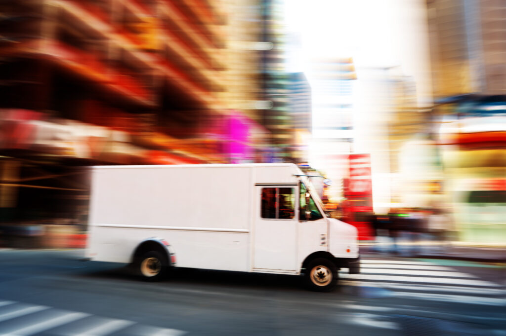 White delivery van speeding in the city