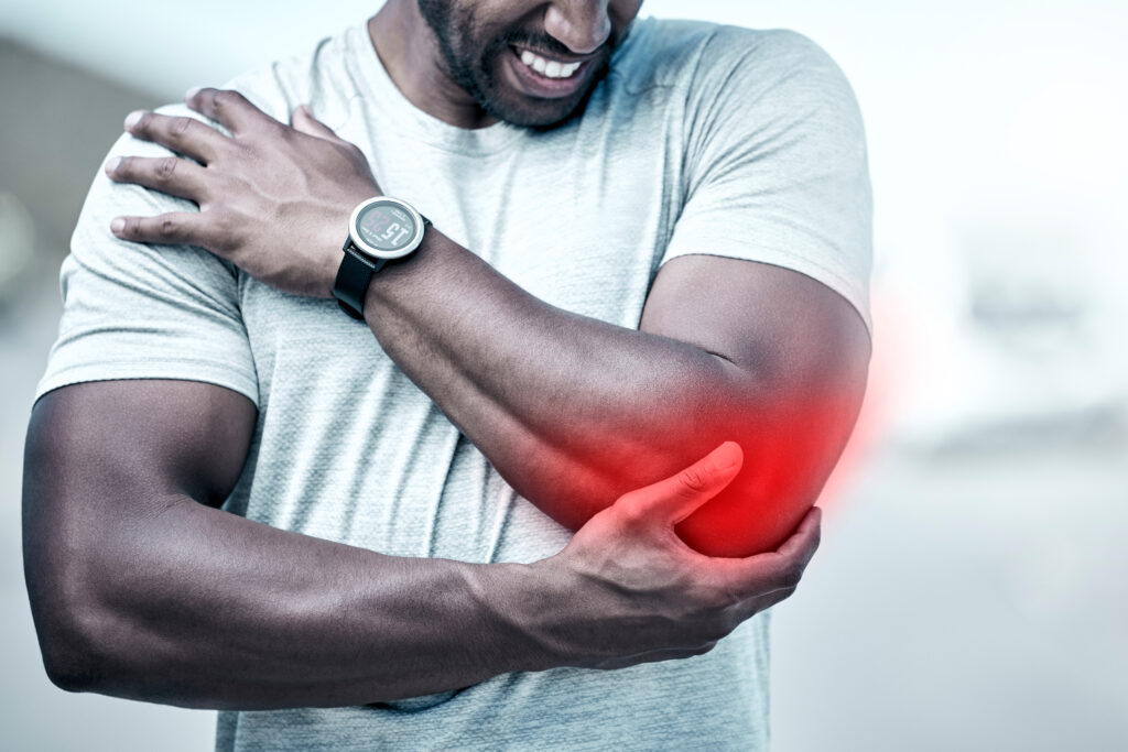 man holding his elbow in pain after a personal injury accident