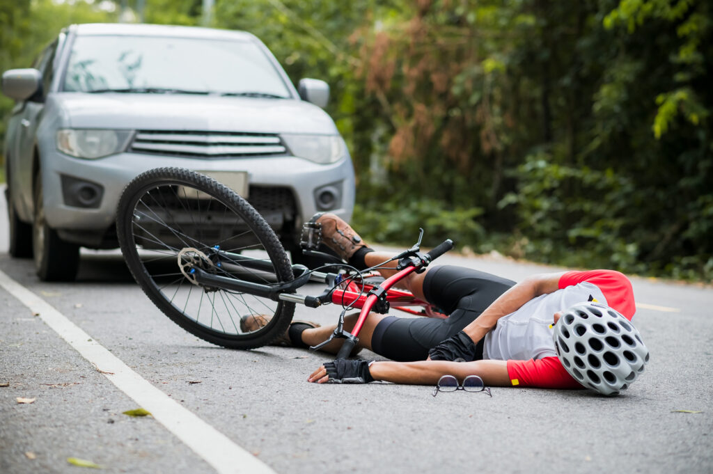 A mountain biker was injured in a collision with a car on the road. 