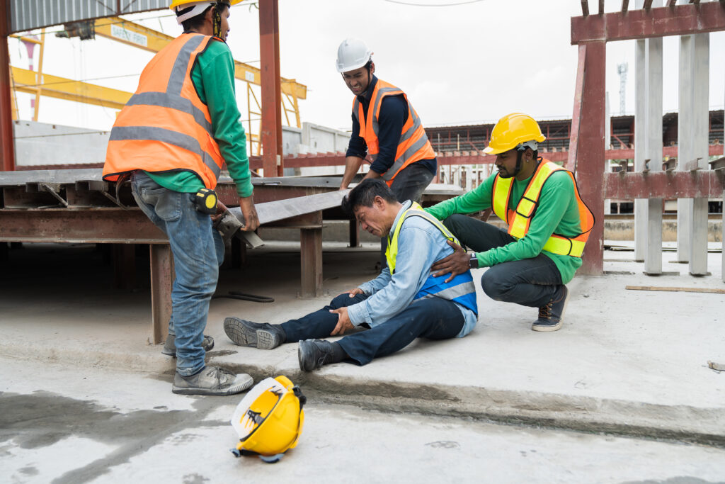Asian male worker accident at his leg at construction site. Industrial accident concept, workers compensation benefits concept