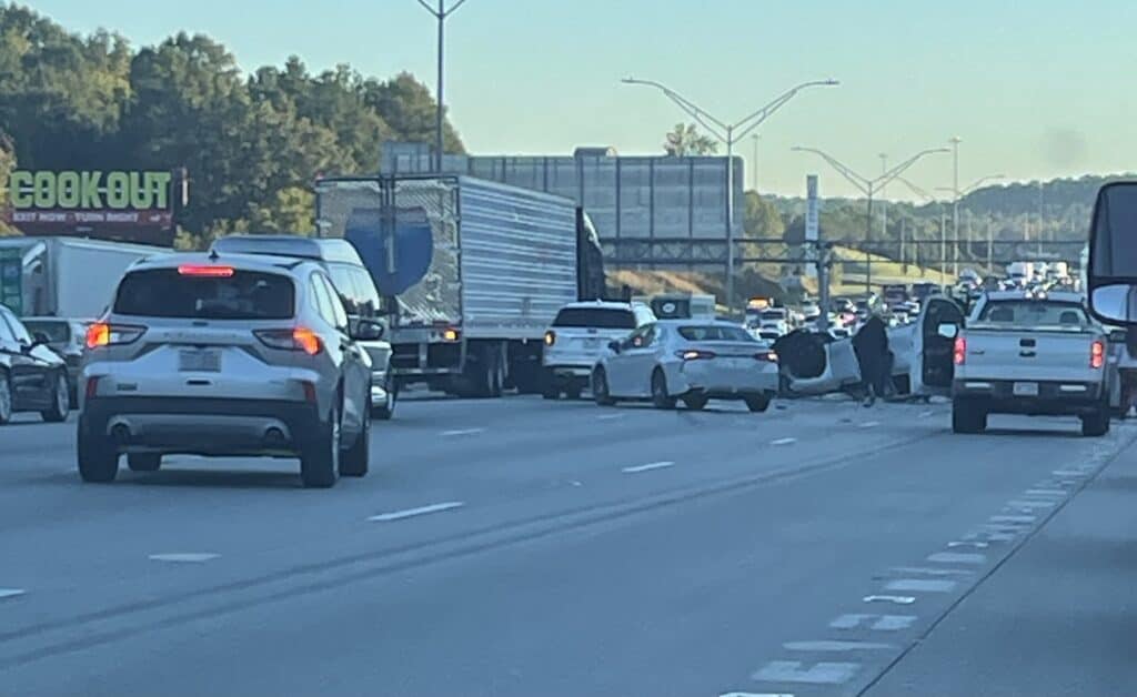 A large semi truck maneuvers around traffic after an accident on I-85 in Charlotte, NC on October 17, 2024.